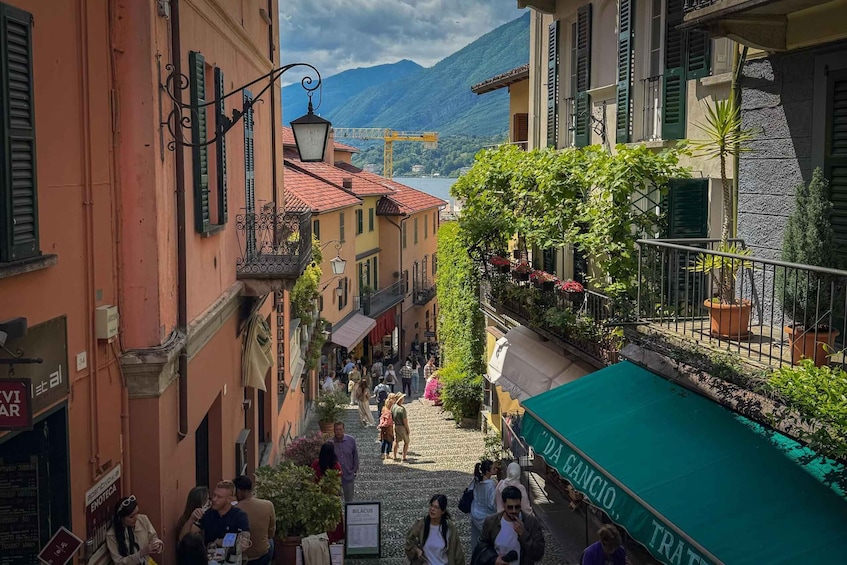 A bustling street with pedestrians, a café, and a mountain backdrop. 4