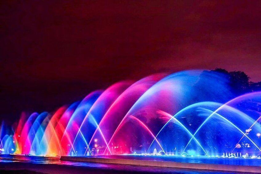 A nighttime water fountain display with vibrant lights. 3