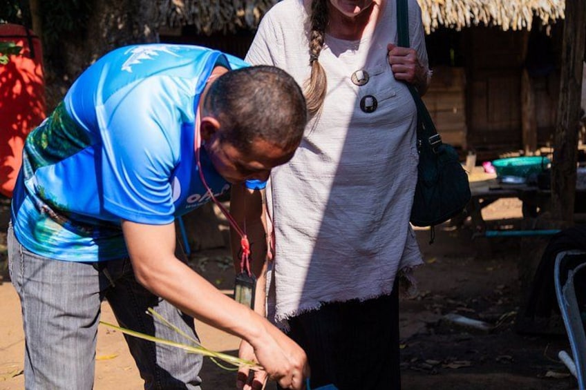 A person in a blue shirt bending over, possibly working with a tool or object. 4