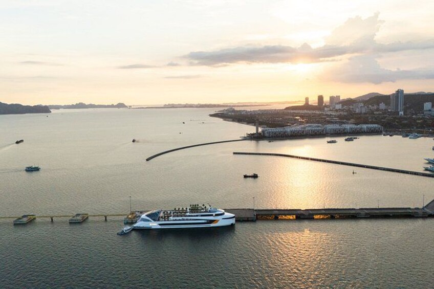 A coastal cityscape with a large body of water, a prominent bridge, and several boats. 3