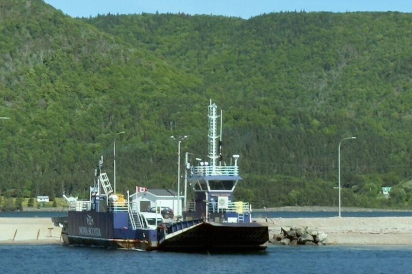 A large vessel named 'NOVA SCOTIA' docked at a pier with a forested hill in the background. 4