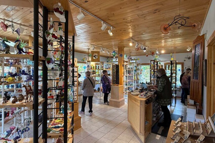 A wooden interior with shelves of glassware and decorative items. 2