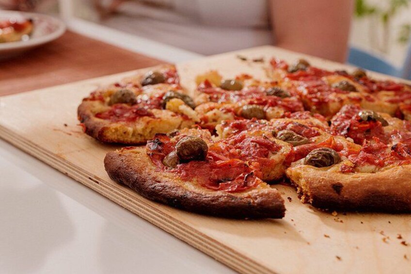 A wooden cutting board with several slices of pizza topped with various ingredients. 5