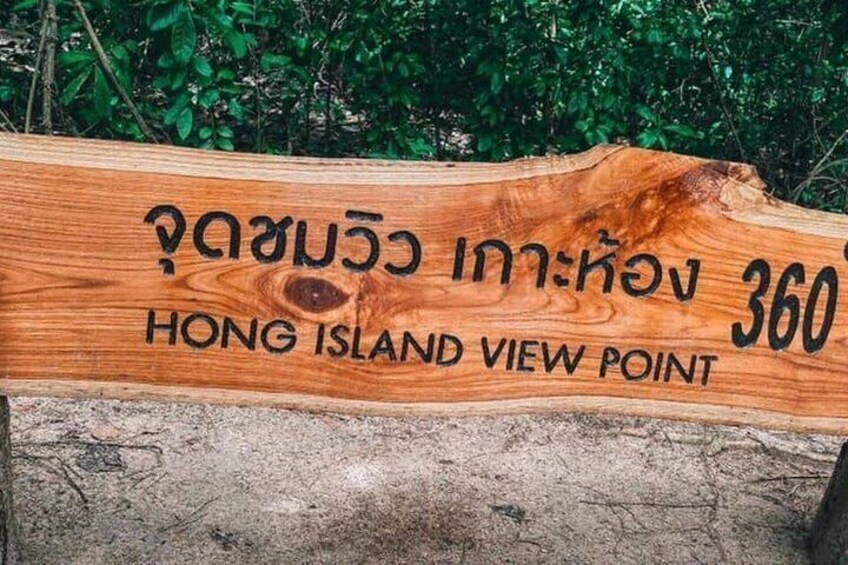 A wooden sign with Thai and English text indicating 'HONG ISLAND VIEW POINT.' 1