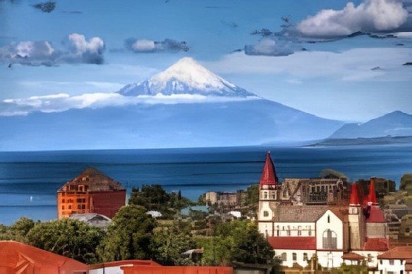 A coastal town with a prominent church, a mountain in the background, and a body of water. 2