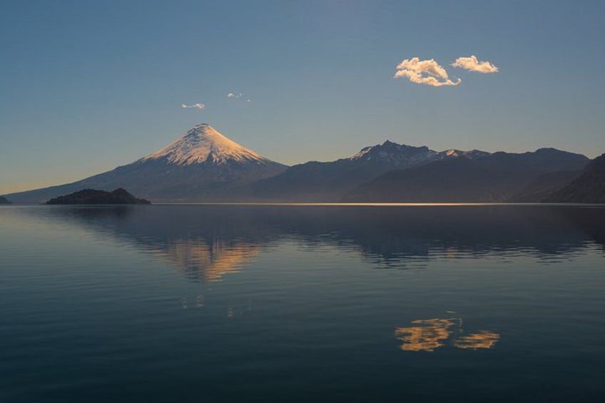A calm lake with a snow-capped mountain in the background. 5
