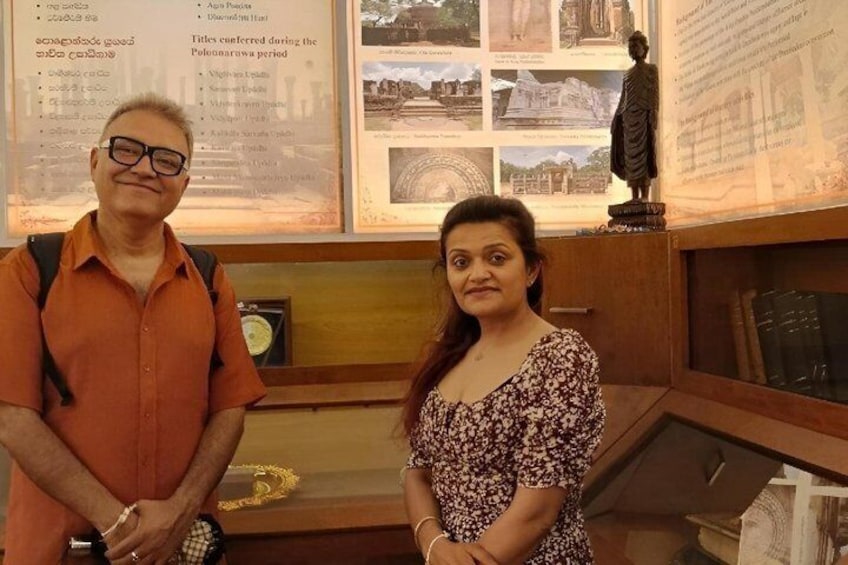 Two people standing in front of a display with historical information and photographs. 4
