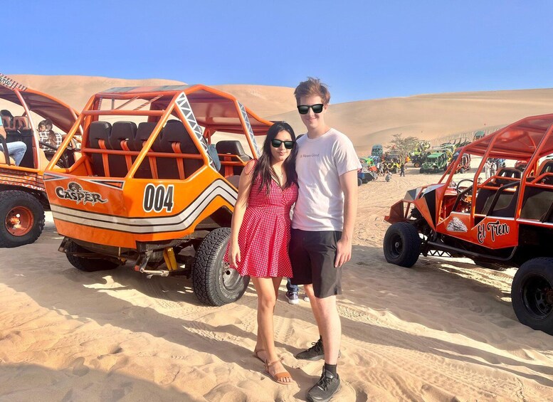 A desert landscape with off-road vehicles and people. 2