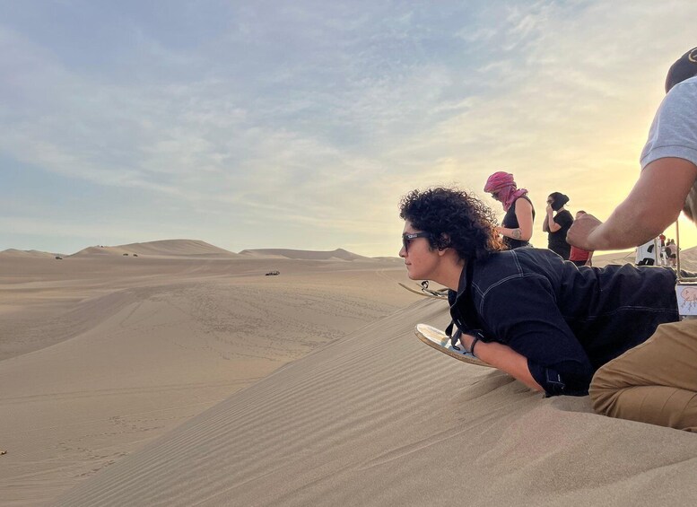 A desert landscape with sand dunes and a vehicle in the distance. 5
