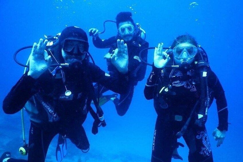 Tres buzos escafandra abajo del agua. 1