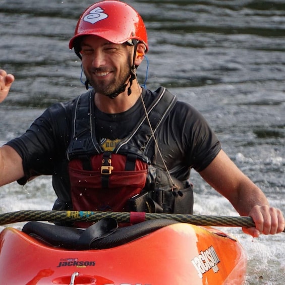 A person on a Jackson kayak on water. 3