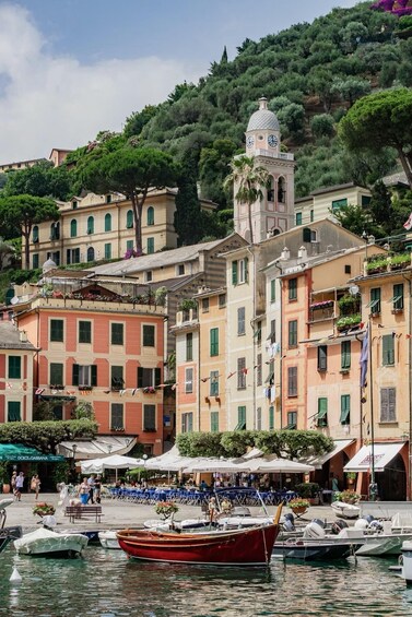 A coastal town with colorful buildings, a prominent clock tower, and boats docked in the marina. 4