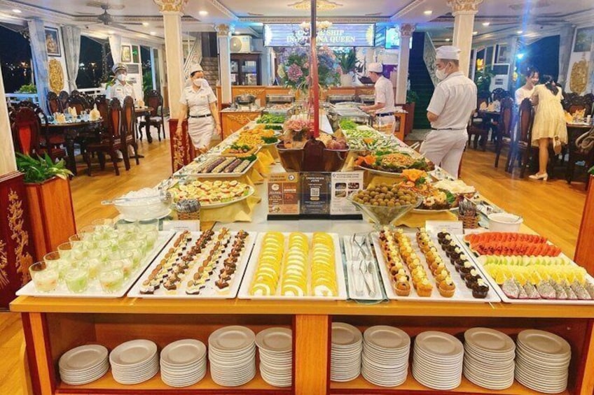 A buffet with various food items and plates arranged on a table. 5