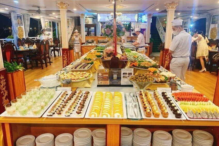 A buffet with various food items and plates stacked underneath. 2