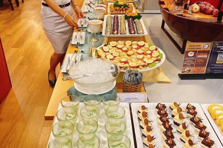 A buffet with various food items and a person serving. 3