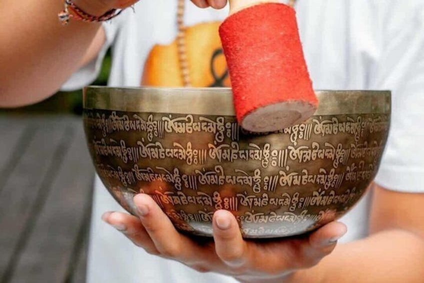 A person holding a bowl with a red object inside it. 4