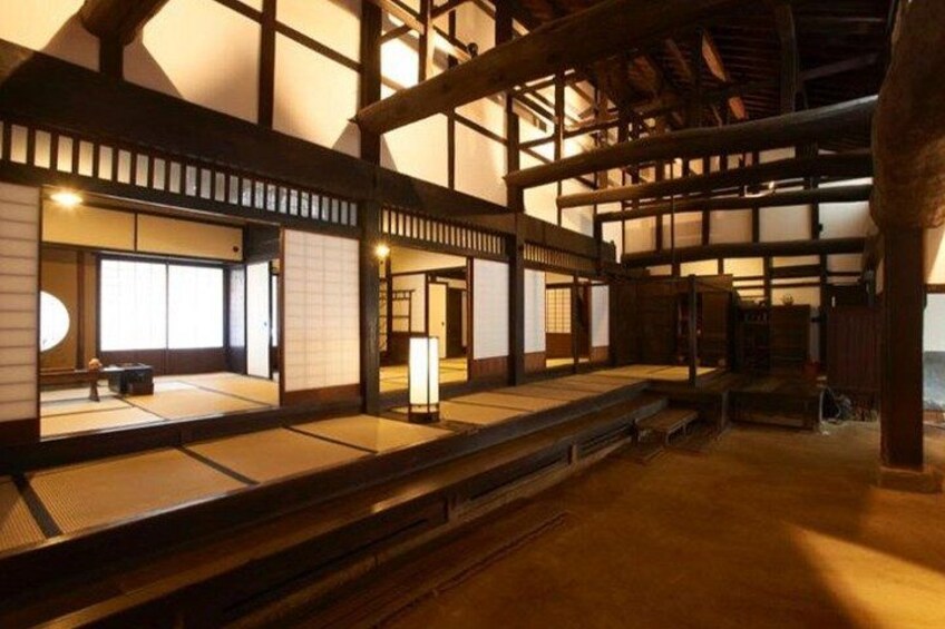 A traditional Japanese building with tatami mats, wooden beams, and sliding doors. 4