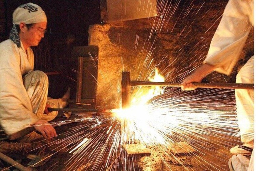 A person working with a tool that generates sparks, likely involved in metalworking or construction. 1