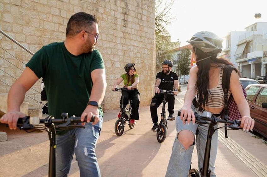 People riding bicycles on a paved path. 1