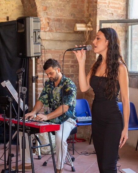 A person singing into a microphone, another person playing a keyboard, and a DJ setup with a mixer and turntables. 5