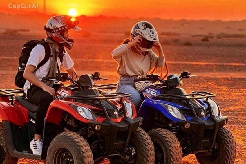 Two people on ATVs at sunset. 2