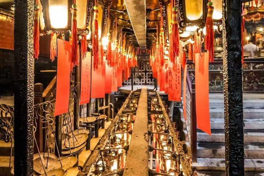 Innenraum eines Tempels mit roten, hängenden Verzierungen und traditioneller chinesischer Architektur. 1