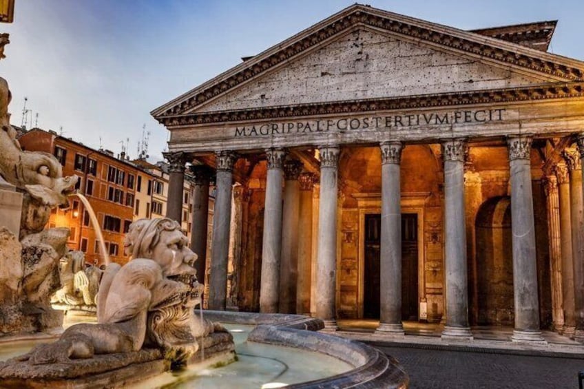 A classical building with columns and a fountain. 1