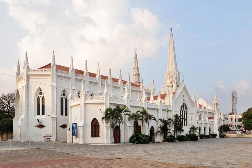 A white church with multiple spires and a red roof. 5
