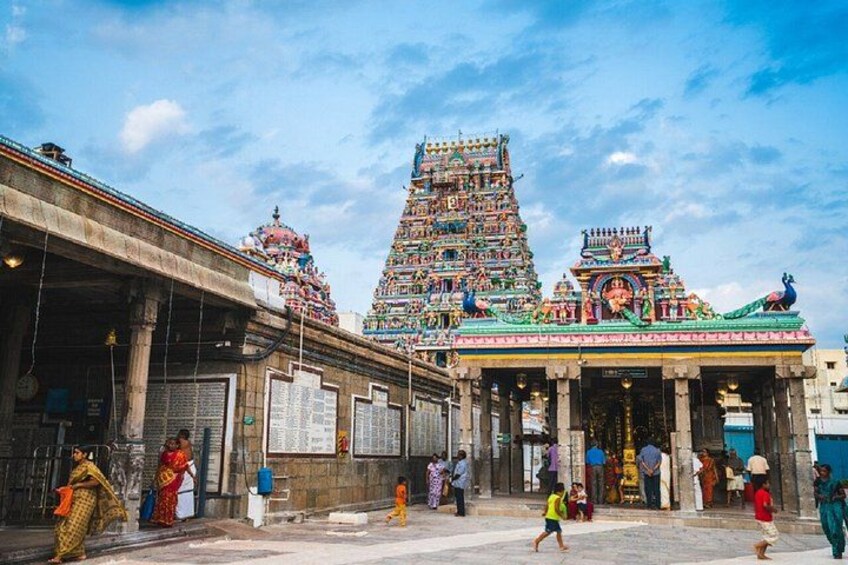 A temple with a multi-tiered tower and a colorful entrance. 1