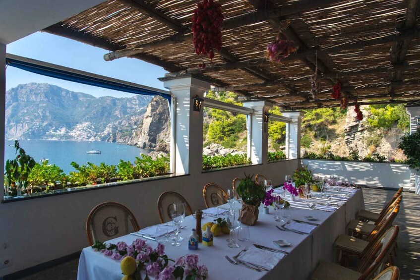 A table set for dining with a view of a coastal landscape. 5