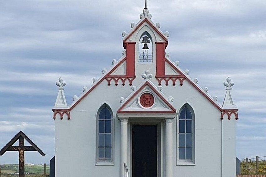 A white church with a red roof and a bell tower. 2