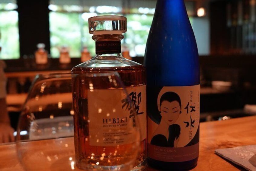 A bottle of Hibiki whisky and a blue bottle with Japanese characters. 4