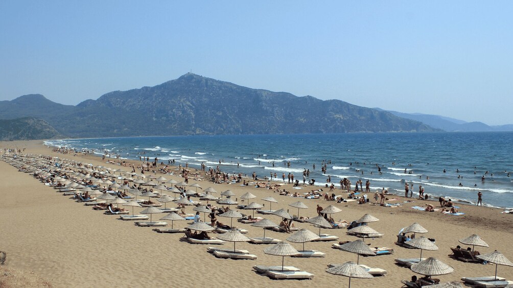 A crowded beach with umbrellas and sun loungers. 5
