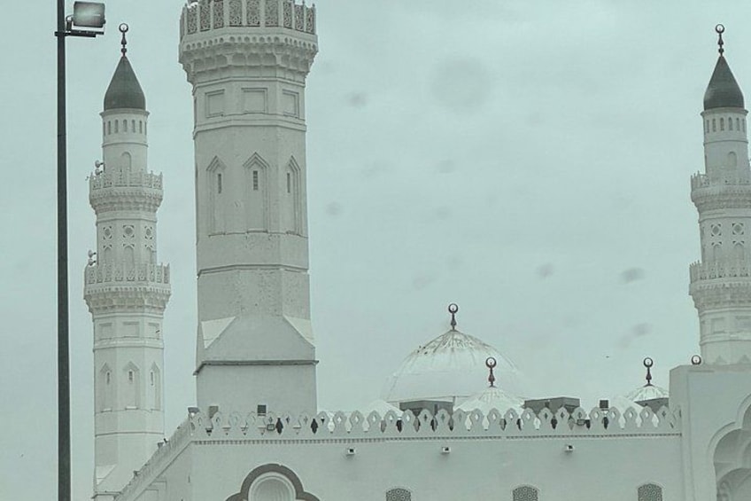 A mosque with two minarets and a dome. 1