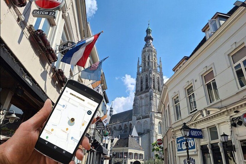 A smartphone displaying a map, a church spire, and a building with a sign reading 'CATCH 22'. 1