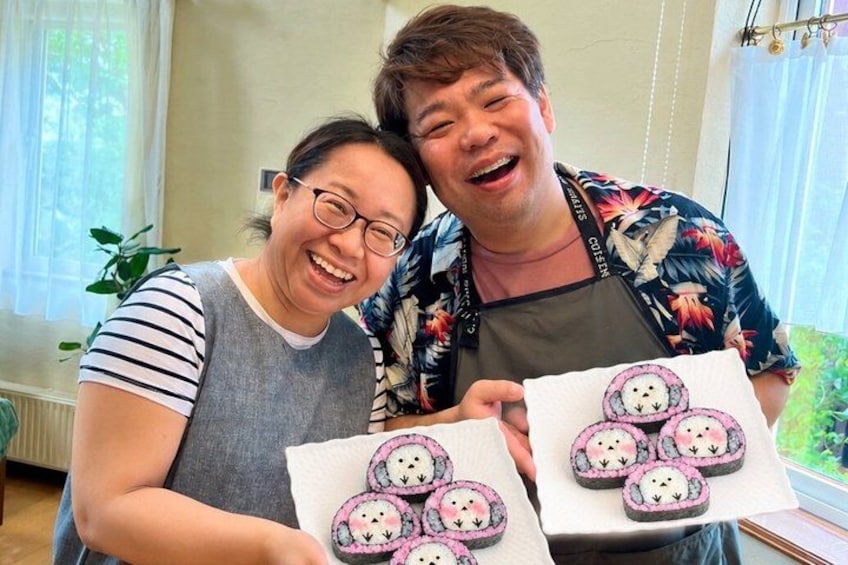 Two people holding plates of decorated food items. 1