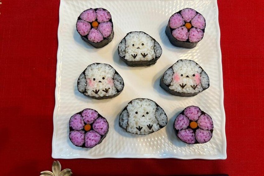 A white plate with sushi rolls arranged in a flower pattern. 5