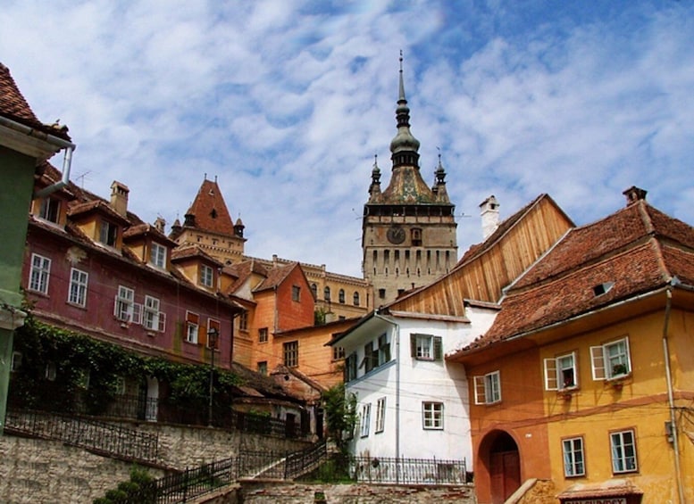 A historic town with colorful buildings and a prominent clock tower. 3