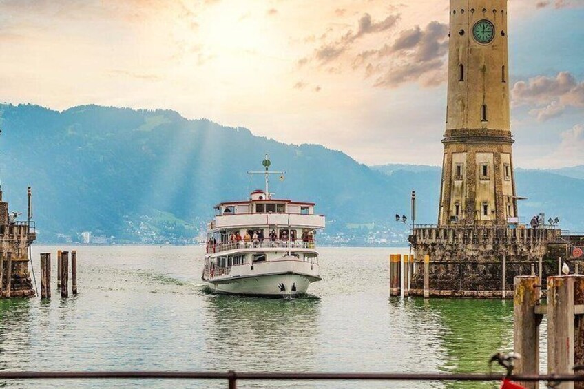 A boat on a lake with a clock tower in the background. 1