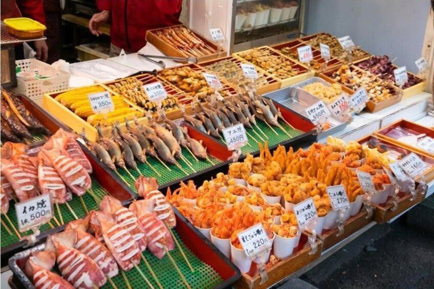 A variety of seafood and meat products displayed at a market stall. 4