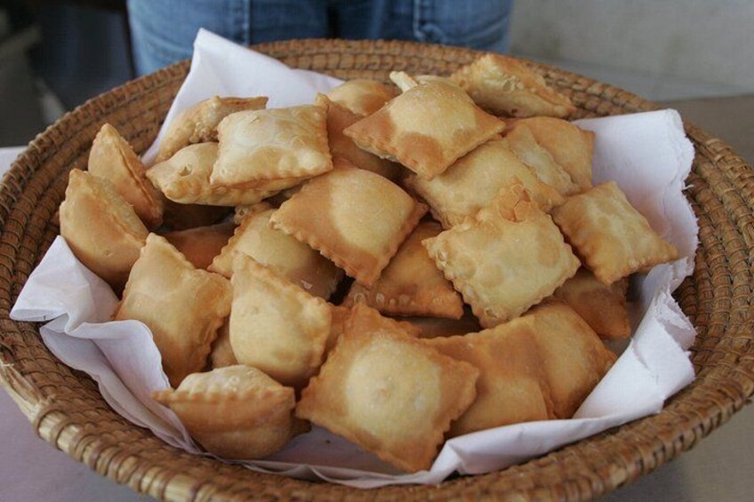 A basket filled with fried pastries. 4
