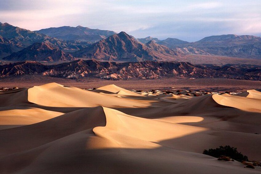 Sand dunes with mountains in the background. 3