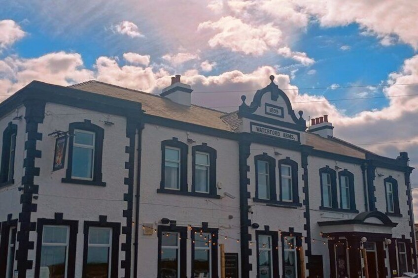 A historic building with a sign reading 'Waterford Arms 1839.' 2