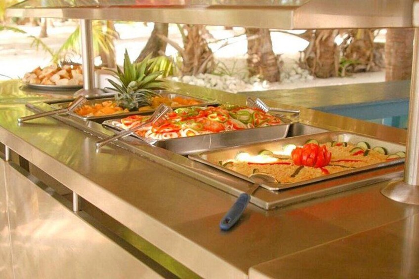 A buffet with various food items, including fruits and vegetables. 1
