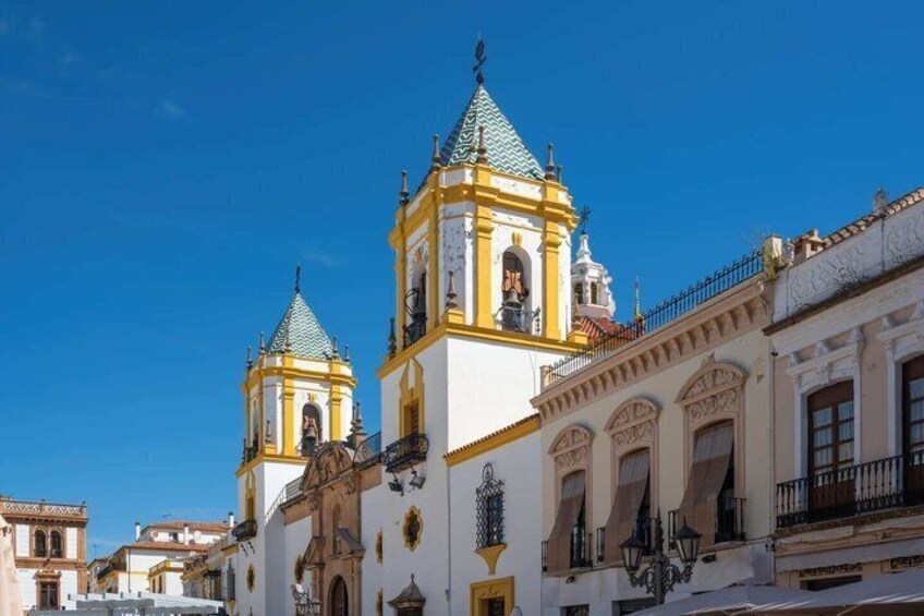A historic building with two bell towers and a white facade. 4