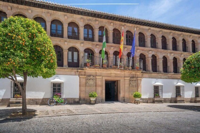 A historic building with arched windows and a courtyard. 5