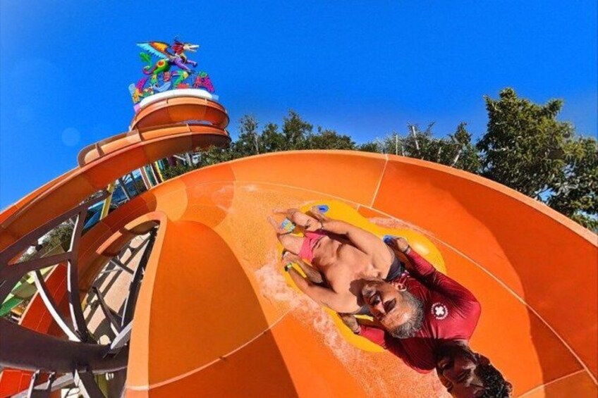 A water slide with a colorful top section and a person sliding down. 5