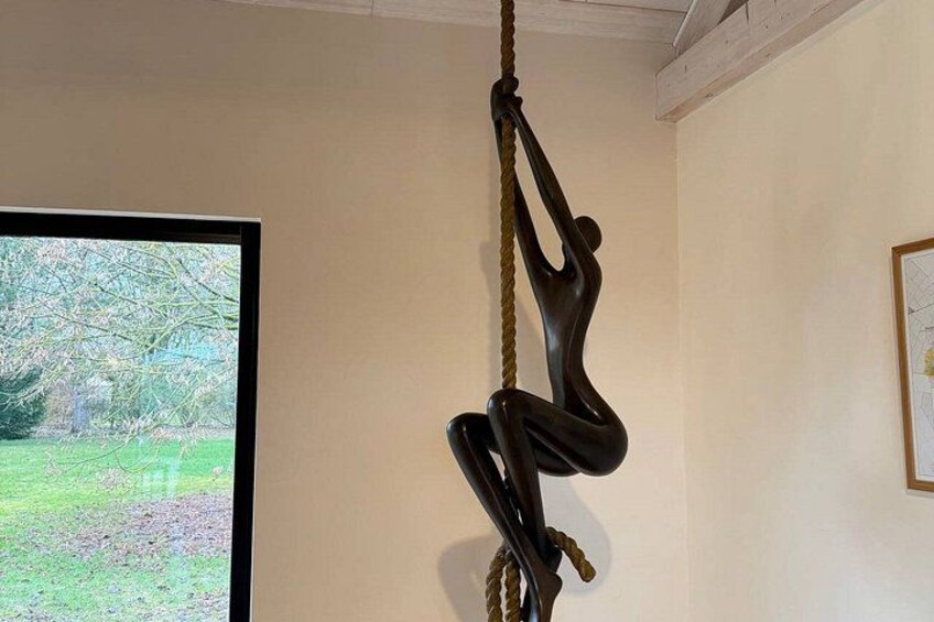 A sculpture of a person climbing a rope. 2