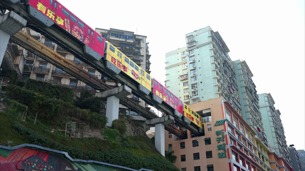 A train on an elevated track passing by high-rise buildings. 1