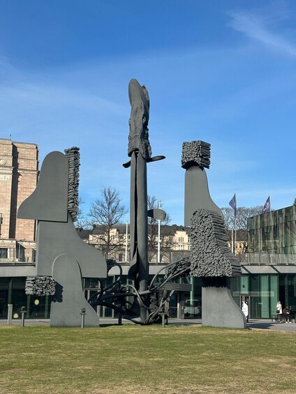 A modern sculpture with abstract shapes and a tall central pillar. 4